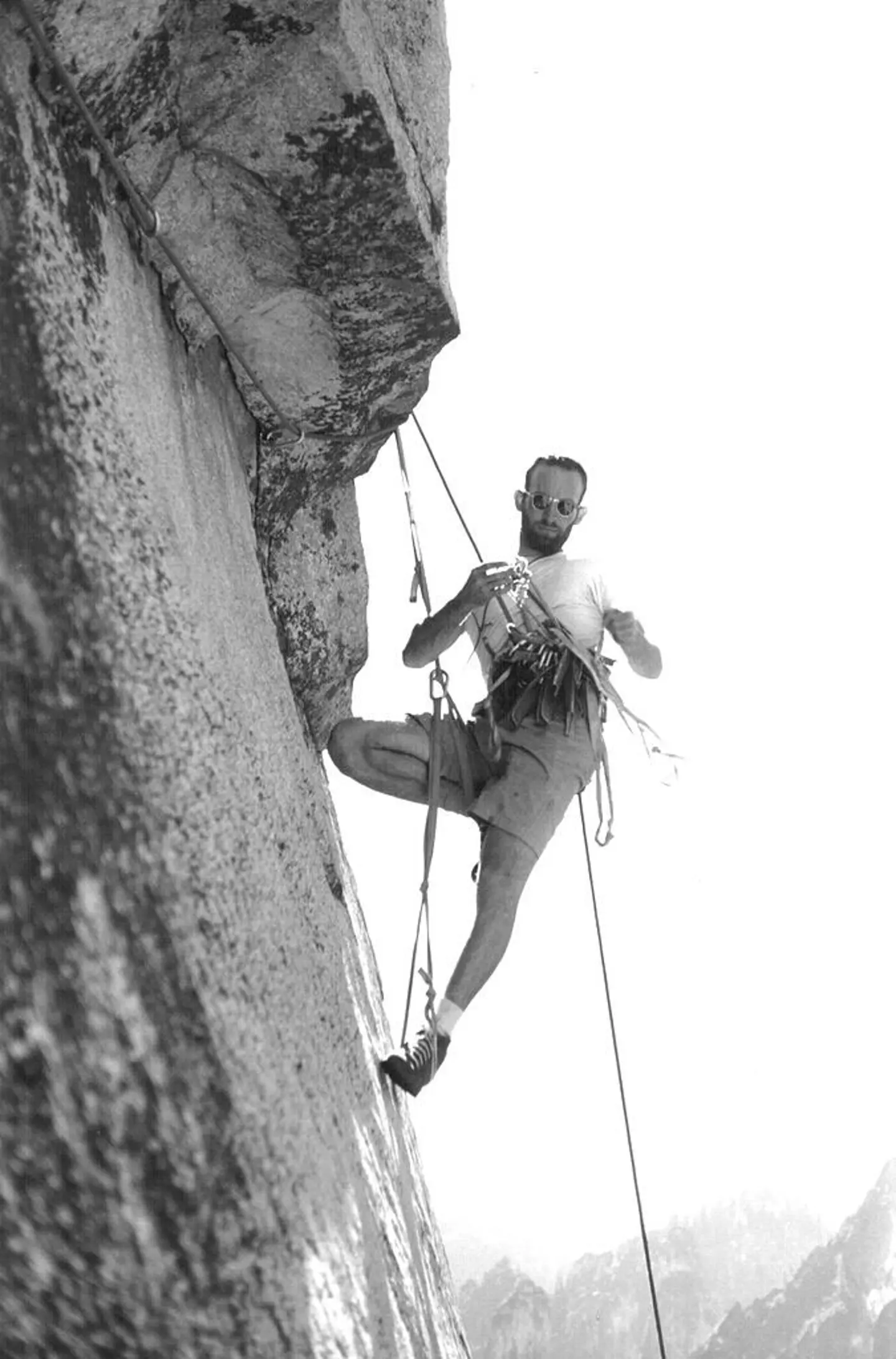Royal Robbins 在 El Capitan 上,他的 harness 上挂满了攀登所需的工具。